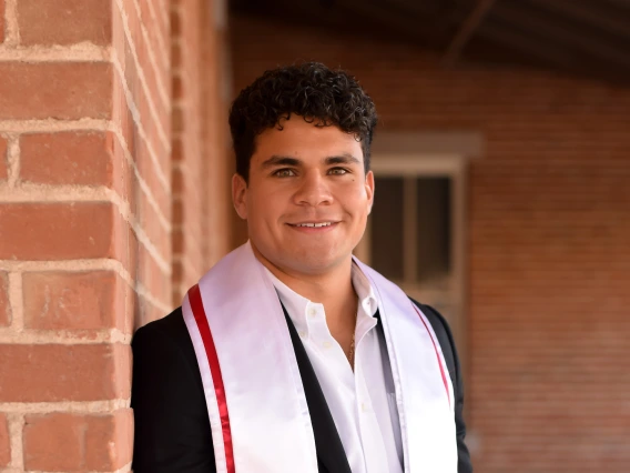 Grad on Old Main veranda